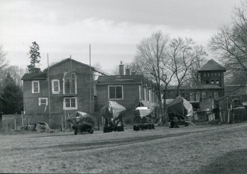 Covered Boats In Front of New Town Houses