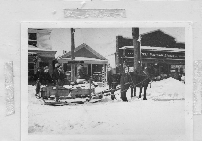A horse-drawn sleigh on Whitfield Street, 1934. The First National Store is in background.