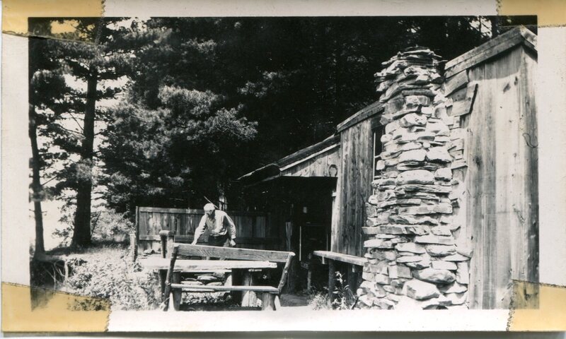 Charles Hubbard working outside at Camp Flapjack in Maine, 1947.