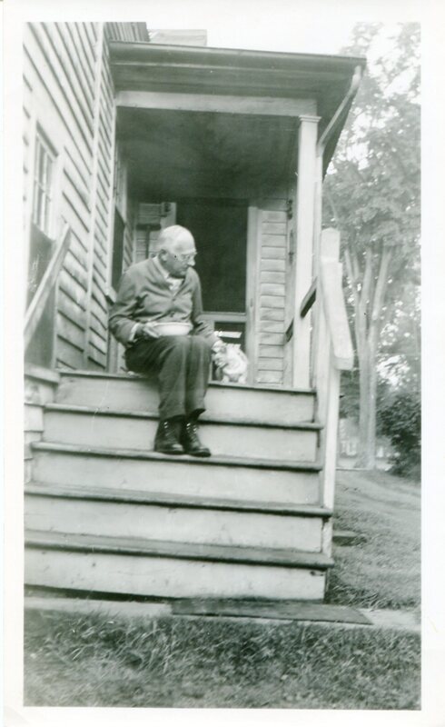 Guilford artist Charles Hubbard sitting on steps