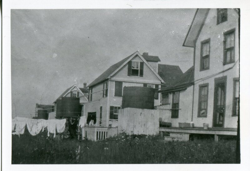 Cisterns and Laundry Lines Along Backs of Cottages